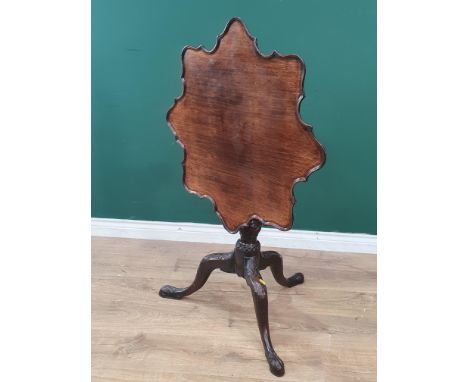 A Georgian mahogany tilt-top Table with shaped dished top on fluted and spiral turned column and carved tripod base, 2ft 5in 