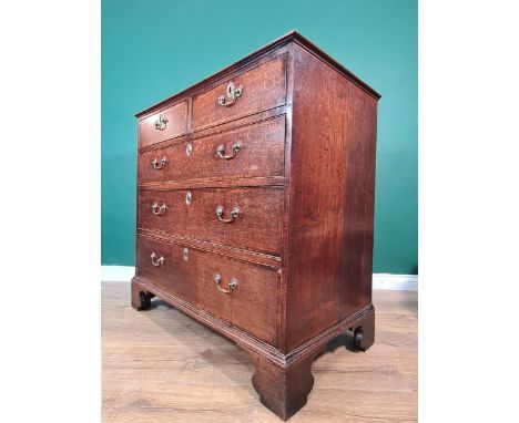 A late Georgian oak Chest with cross-banded top above two short and three long drawers on bracket feet, 3ft 3in 