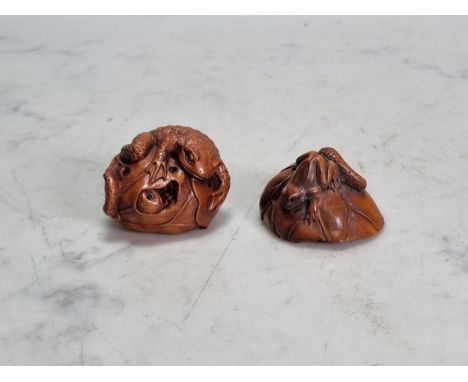 Two Oriental carved wood Netsuke, frogs on a lily pad, and a toad, 1 1/2in, bear signatures  A few chips to the edge of the l