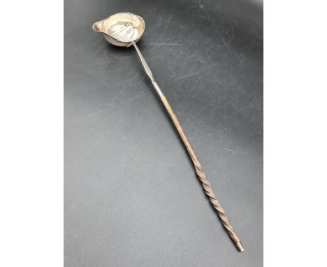 A Georgian Toddy Ladle with coin inset oval bowl, spiral whalebone handle 