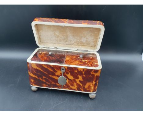A 19th Century tortoiseshell Tea Caddy with two interior lidded compartments, silver cartouche engraved crest and initials, r