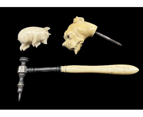 19th century walking stick finial in the form of a dogs head with glass eyes, a carved ivory model of a sleeping pig L5cm and