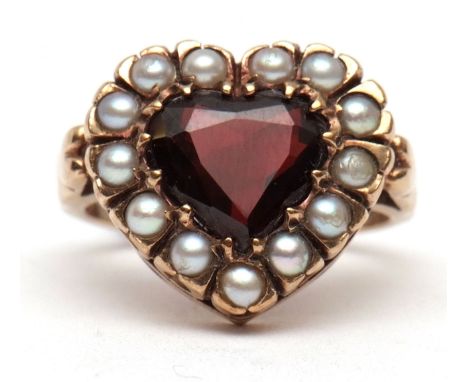 9ct gold garnet and seed pearl ring, the faceted cut heart shaped garnet within a seed pearl surround, all in a pierced galle