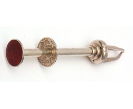 Aksel Holmsen, Norwegian enamelled white metal ice gripper, push button mechanism, the top with a red guilloche enamelled des