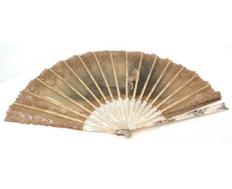 Late 19th century mother of pearl and gilt highlighted 18 stick fan with engraved and highlighted floral detail to a painted 