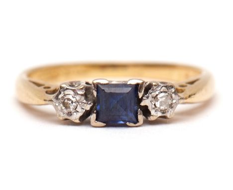 18ct gold sapphire and diamond ring, the central square cut small sapphire between two small single cut diamonds, all in a ra