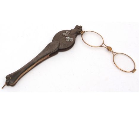 Late 19th century mother of pearl and gilt metal mounted folding lorgnette, the grips decorated with flowering iris and fitte