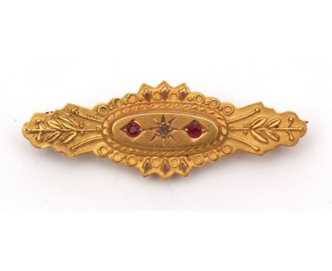 Edwardian 15ct gold diamond and ruby bar brooch, oval shaped with a raised central panel set with a small rose cut diamond be