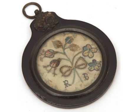 Small 19th century framed sampler, the ebonised circular case with floral and ring mount to a glazed circular panel set with 