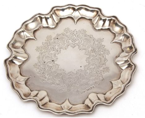 Edward VII salver, of shaped circular form with engraved field and raised on one (of three) button feet, 7 1/8 ins diam, weig