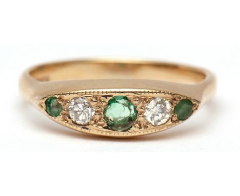 Modern 9ct gold diamond and emerald ring, the boat shaped panel set with 3 graduated circular small emeralds and 2 small bril