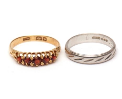 Mixed Lot: Platinum wedding ring with a chased design, finger size K, 3.2gms, together with a yellow metal and 5-stone garnet