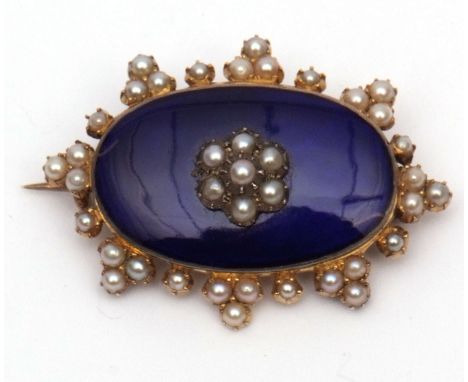 Victorian gilt metal, enamel and seed pearl brooch, the dark blue enamelled panel applied to the centre with a seed pearl flo