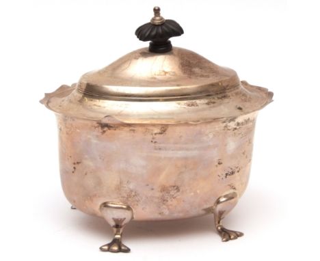 George V tea caddy of oval form with cut card rim, hinged and domed cover and raised on four cast and applied feet, width 5in