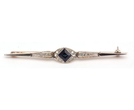 Precious metal Art Deco diamond set bar brooch, the centre a square cut blue coloured stone, the pierced bar highlighted with