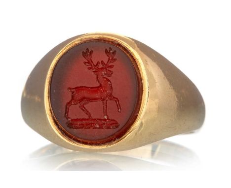 CARNELIAN SEAL RING, the stone carved with a stag, marks rubbed, size JQty: 5.2gItem is gold however the marks are indistinct