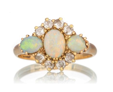 OPAL AND DIAMOND RING,  the central opals flanked by small diamonds, in eighteen carat gold, size QQty: 3.6g