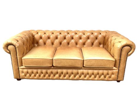 Modern tan chesterfield three seat buttoned sofa, 70 x 188 x 90 cm.