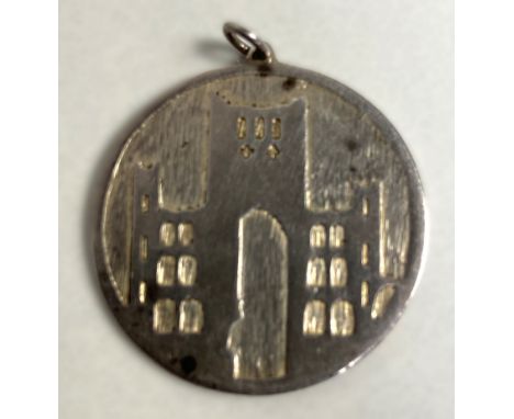 A Norman Cherry, Scottish silver pendant depicting Kelso Abbey, hallmarked Edinburgh 1979, 3cm, 9g.