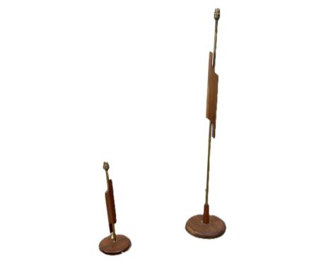 A mid century teak and metal standard lamp with abstract design to centre, 126cm, and a matching table lamp, (2)