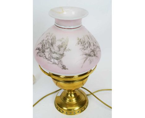 Brass oil lamp, the pink shade decorated with prints of birds