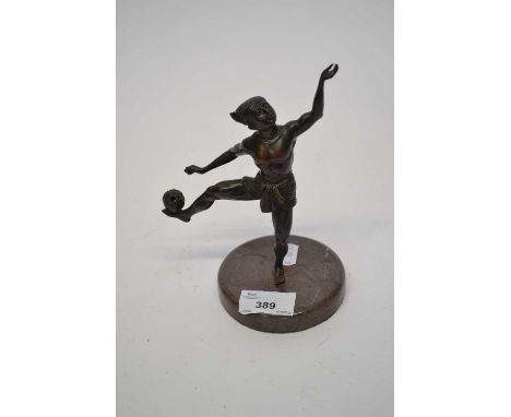 Spelter model of an Indonesian juggler or dancer on circular onyx base, 30cm high