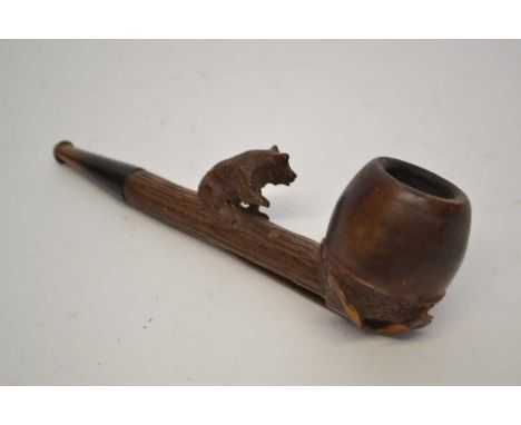 A black forest style carved wooden pipe the stem with a carved bear with carved floral decoration below.15cm long