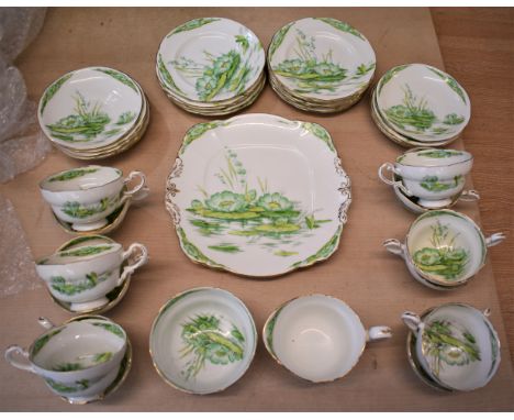 Royal Paragon 'Water Lilly' pattern fine bone china, made in England. Includes 11 saucers, 12 cups, 1 milk jug and 1 sugar ba