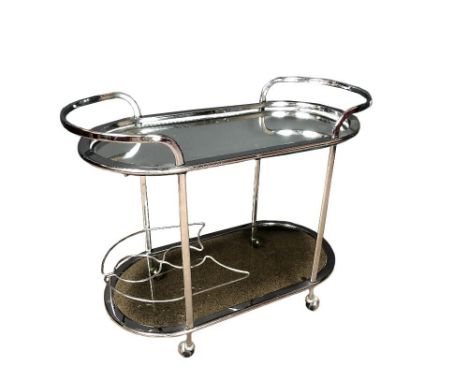 A 1970's chrome two-tier drinks trolley, with mirrored top, the lower tier with smoke glass and integral bottle caddy 69 x 85