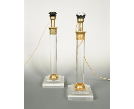 A near pair of 20th century gilt mounted acrylic table lamps, each of columnar form raised on stepped square bases, the talle