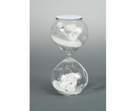 § Daniel Arsham (American, born 1980), Hourglass, 2018, glass, resin and sand, the sand running through the hourglass to reve