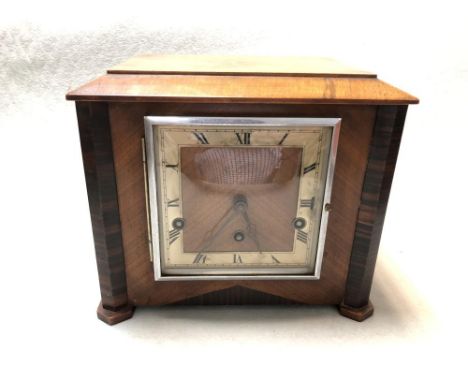 An Art Deco walnut mantle clock, the rectangular case with angled coromandel front corners and 13.5cm square dial, with three