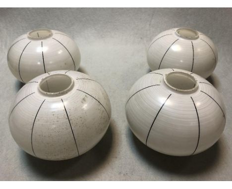 A set of four Art Deco hand-painted glass light shades, of compressed spherical form with black line decoration 12 x 15cm (5 