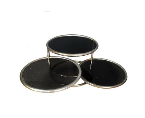 A 1970's chrome and glass coffee table, the circular top above two pivot fold tiers below 40 x 57cm (16 x 22in)  
