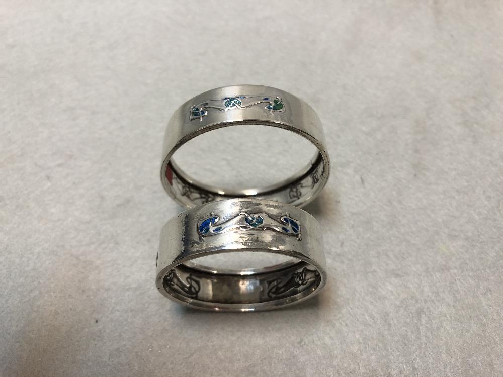 Liberty & Co., two similar silver and enamel napkin rings Birmingham