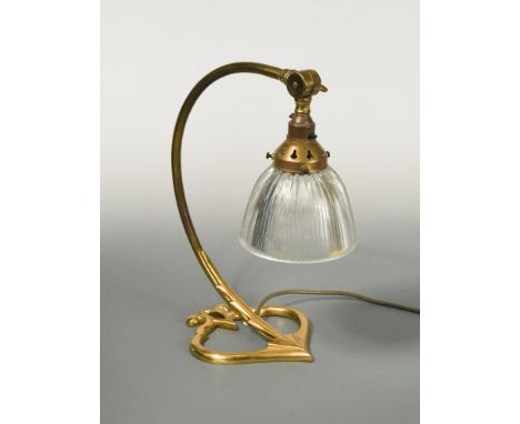 In the manner of W.A.S. Benson, a brass table lamp, the curving arm supporting the original glass shade 36cm (14in)  