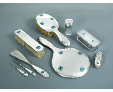 Liberty & Co., a silver and enamel dressing table set, various dates, comprising mirror, hair brush, straight brush, a scent 