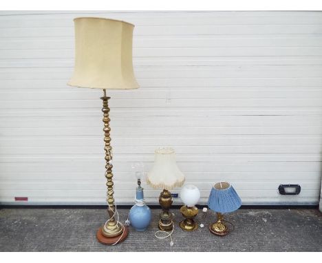 A brass standard lamp, three brass table lamps and one other (5)