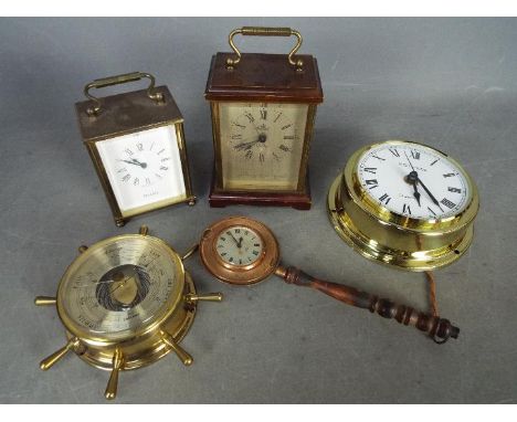 A small collection of clocks and a barometer.