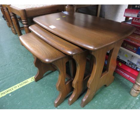NEST OF THREE ERCOL MID ELM OCCASIONAL TABLES.