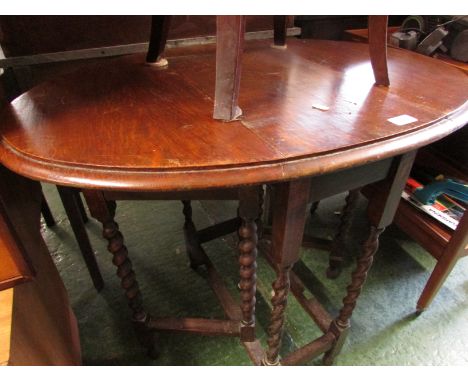 SMALL OAK OVAL GATE LEGGED TABLE ON BY TWIST SUPPORTS.