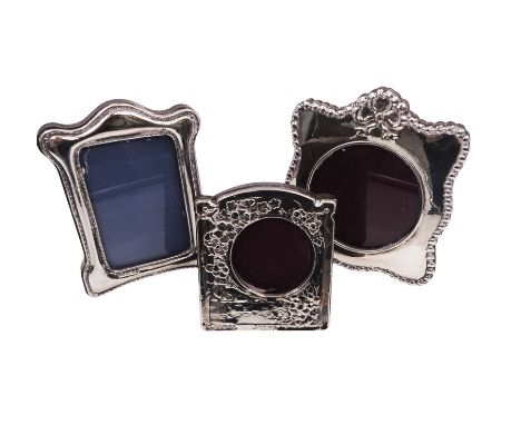 Three modern Britannia silver mounted photograph frames, to include a shaped example, with husk border and ribbon decoration 