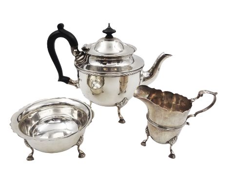 1920s three piece silver tea service, comprising teapot, with ebonised wooden handle and finial, milk jug and open sucrier, a