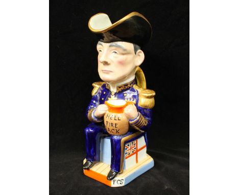 A Wilkinson pottery Toby jug designed by Sir Francis Carruthers Gould, depicting Admiral John Jellicoe, holding a jug and ins