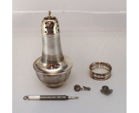 A silver sugar caster of baluster form with engine-turned decoration, Birmingham, 1936, together with a napkin ring, retracti