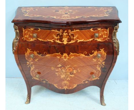 A Sorrento style serpentine front, marquetry bombé commode, with three long graduated, oak lined drawers and raised on splaye