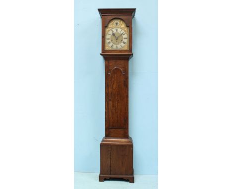 An early 20th Century stained oak longcase clock, the brass dial with Roman numerals denoting hours, strike silent feature, s
