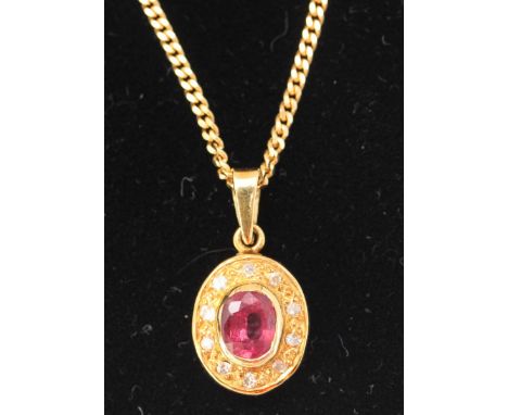 An 18ct gold fine necklace chain with 18ct gold oval pendant set with an oval ruby surrounded by ten small diamonds, 5.02g