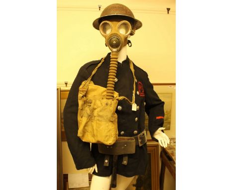 A WWII Auxillary Fire Service-Portsmouth fireman's coat, helmet, gas mask, belt and fireman's axe, as worn by and former prop