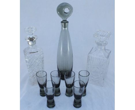 A smokey glass decanter of slender, ovoid form, possibly by Dartington and a matching set of six liqueur glasses of waisted f